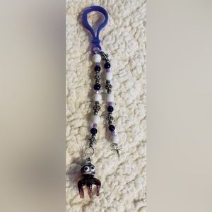 Handmade Glass octopus with metal cross keychain.